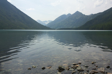Fototapeta na wymiar Lake in the mountains between the mountain peaks.