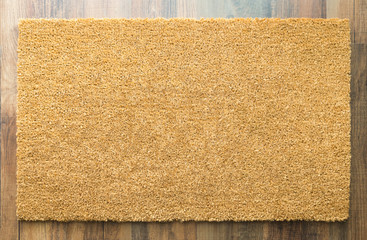 Fototapeta na wymiar Blank Welcome Mat On Wood Floor Background Ready For Your Own Text.