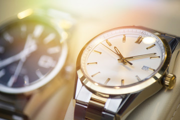 Beautiful stainless steel watch in front of other watches. Focus on the watch.
