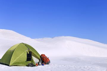 Camping in the desert with a backpack and tent.