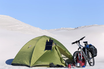 Camping in the desert with a backpack and tent.