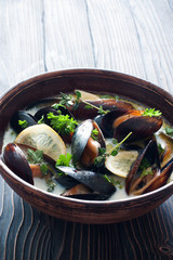 Mussels with lemons and herbs in broth