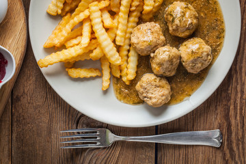 Meatballs with french fries in dill sauce.