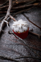 Chocolate cupcakes with white butter cream, decorated withstarson a dark wooden background.
