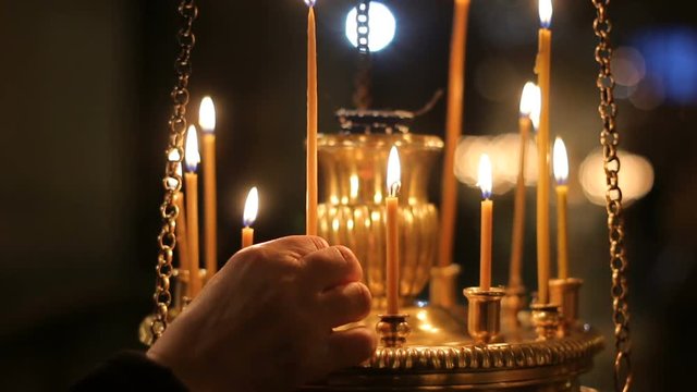 hand parishioners of the lights and lighting a candle in the candlestick in the Church