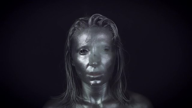 4K Horror Woman with Silver Metallic Make-up Smoking in Reverse
