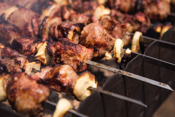 Cooking meat on the fire. Shish kebab on the grill (top view)