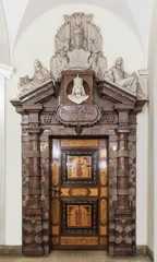 Carved Wooden Door. Historic wooden door with a sign Praesplum.
