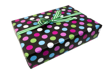 Isolated polka dot wrapped present with green striped bow. Copy space above. Horizontal.