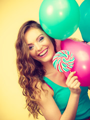 Woman with colorful balloons and lollipop