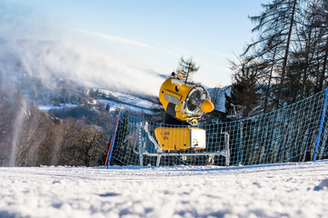 Snow cannon produces artificial snow on the ski slopes