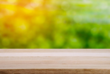 Empty wooden table and landscape background of forest lake and sky with sunshine. 