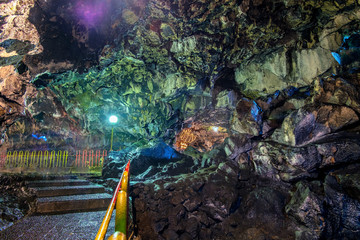 Beautiful cave floor and colorful cave wall in cave passage, illuminated by lamp,  Captured from Lawa cave, Purbalingga, Indonesia. © Adnan