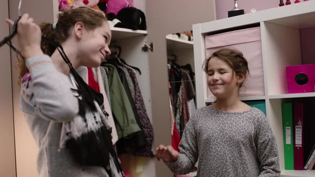 Sisters picking out clothes to wear