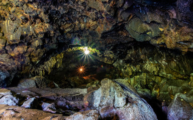 Beautiful cave floor and colorful cave wall in cave passage, illuminated by lamp,  Captured from Lawa cave, Purbalingga, Indonesia. © Adnan