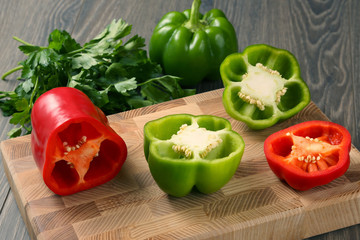 sliced sweet peppers with herbs on a wooden board