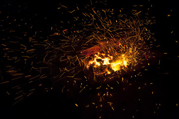 Fototapeta na wymiar Hot sparking live-coals burning in a barbecue