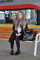 Young woman on a train station.