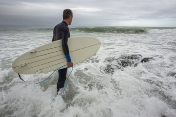 Surfer Entering the Ocean