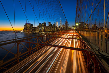 Traffic on the Brooklyn bridge with the Lower Manhattan skyscrapers in the background. Night shot...