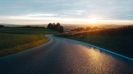 Sunset city road in the field, sun, evening