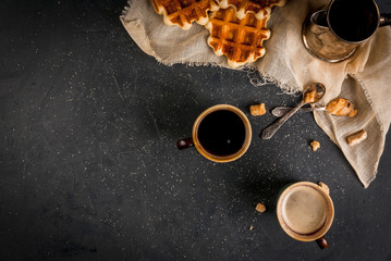 Homemade breakfast, a cozy kitchen, stone table. Viennese waffles, two cups of coffee, coffee, vintage spoon with brown sugar, Top view, copy space