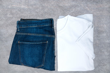 White T-shirt, denim jeans on a wooden board. Top view, Copy spa