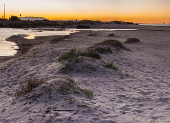 Natural sand berm creates levee for estuary water shoreline.