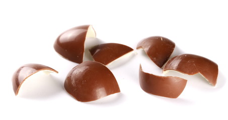 Cracked chocolate egg, isolated on white