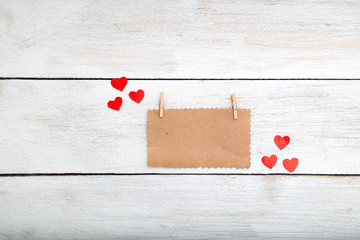 Valentine, a note on the kraft paper lies on a white wooden back