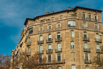 Fototapeta na wymiar brown facaded big apartment building at barcelona