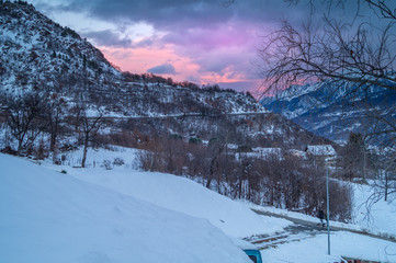 Fototapeta premium sunset in the mountains, the landscape in the snow and pink sky