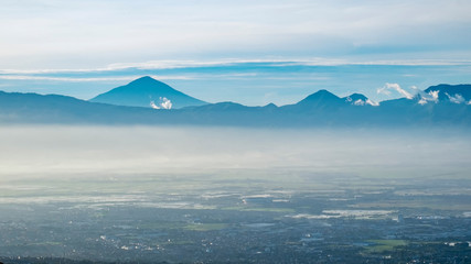 Aerial view of city and mountain when illuminated by sunlight in faraway, captured  from Moko Hills when weather is sunny, Bandung, Indonesia
