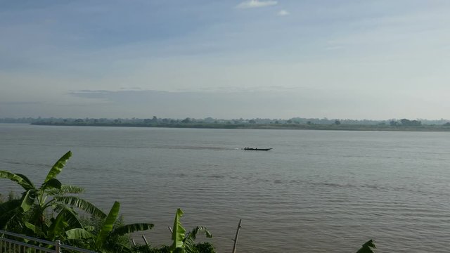 boats floating on the Mekong River carrying goods for the morning laotian market in Mukdahan, Thailand.