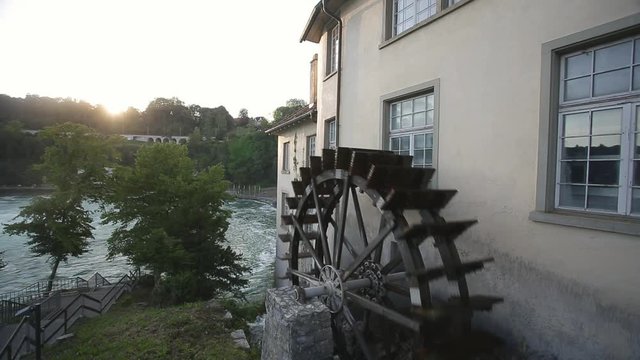 Water mill wheel on the river Rhine falls in Switzerland
