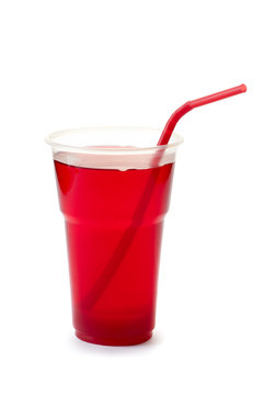 Red drink with straw in plastic cup on white