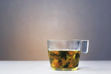 cup and teapot with hot tea of wild herbs. Health, beauty, longevity