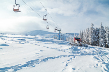 Landscape. Red snowcat and chair lift at ski resort