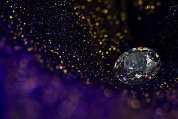 Beautiful big diamond jewelry on dark violet colorful glitter shiny background. Fine natural precious stone.Brillant shine.