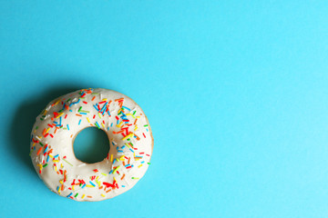 Glazed donut on color background