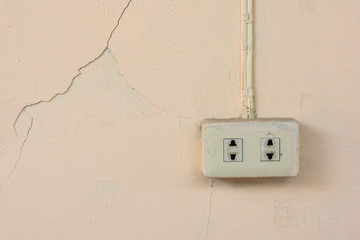 Old power plug socket outlet on old  concrete wall