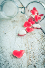 Red heart shape candy in a glass jar