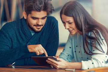 Young couple using a digital tablet