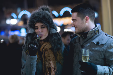 Fototapeta premium Young lovers enjoy on the street at night in the city, the street lights, romance.Under exposed photo