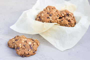Flourless gluten free peanut butter, oatmeal and chocolate chips cookies on cooling rack, horizontal