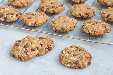 Flourless gluten free peanut butter, oatmeal and chocolate chips cookies on cooling rack, horizontal