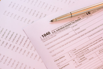 Fototapeta premium US tax form with pen and calculator selective focus / taxation c
