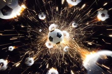 Soccer balls with fire sparks in action black isolate