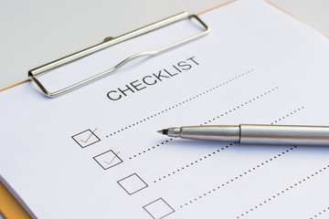Checklist concept - checklist, paper and a pen with checklist wo