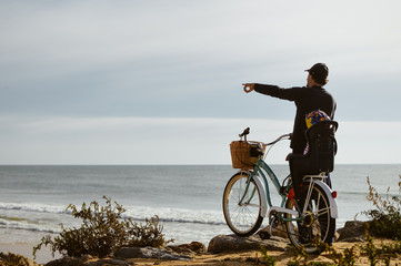 Fototapeta premium Defocused silhouette of child and father with bike on a beach natural outdoor. Travel vacation background